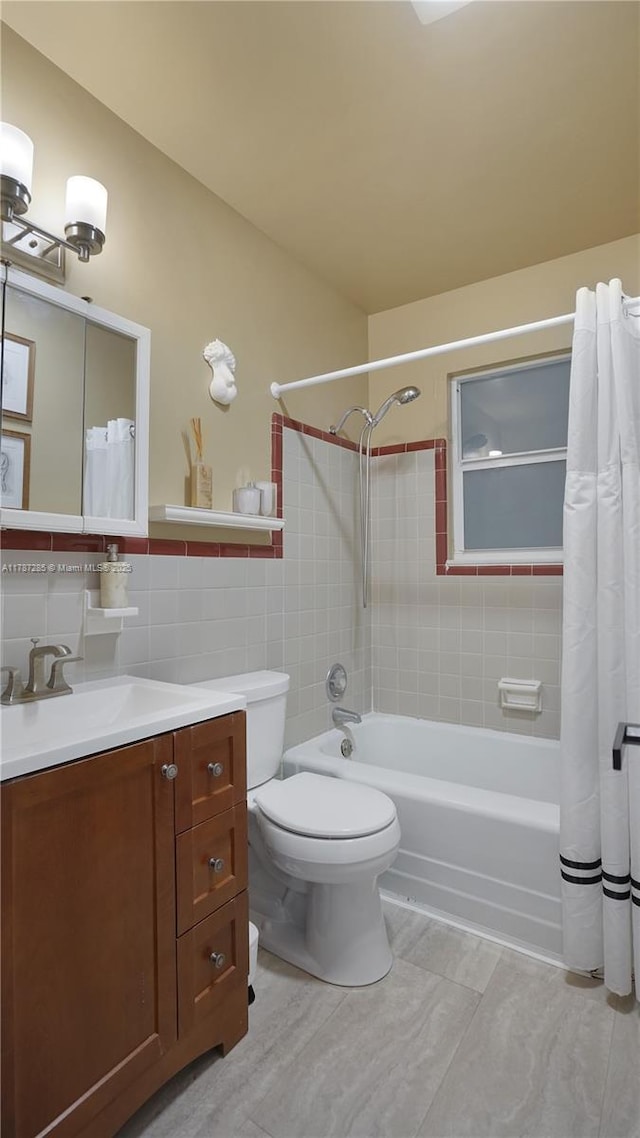 full bath with tile walls, vanity, shower / tub combo, and toilet