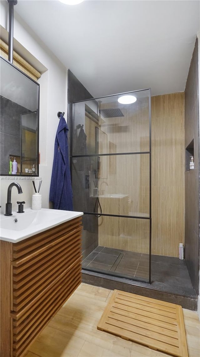 full bath with vanity and a walk in shower