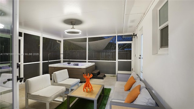 sunroom featuring an outdoor living space and a jacuzzi