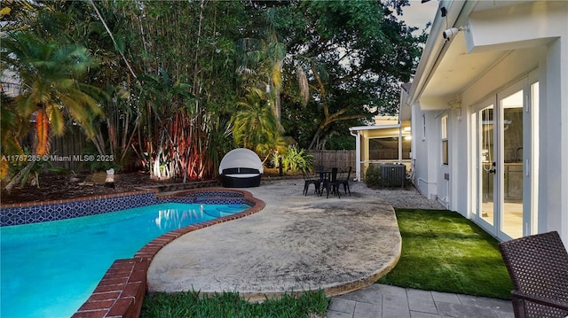 view of pool with a patio area, a fenced backyard, a fenced in pool, and central AC unit