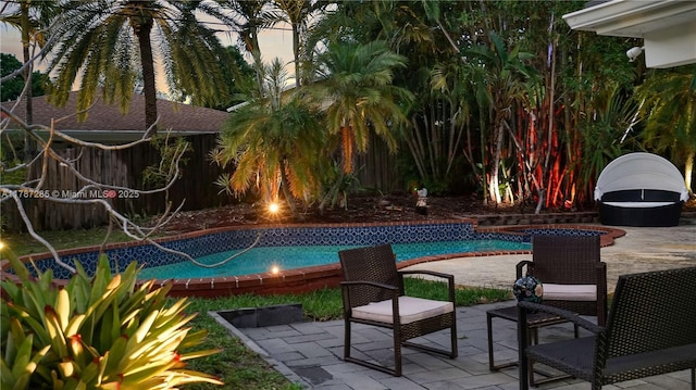 pool featuring a patio area and fence