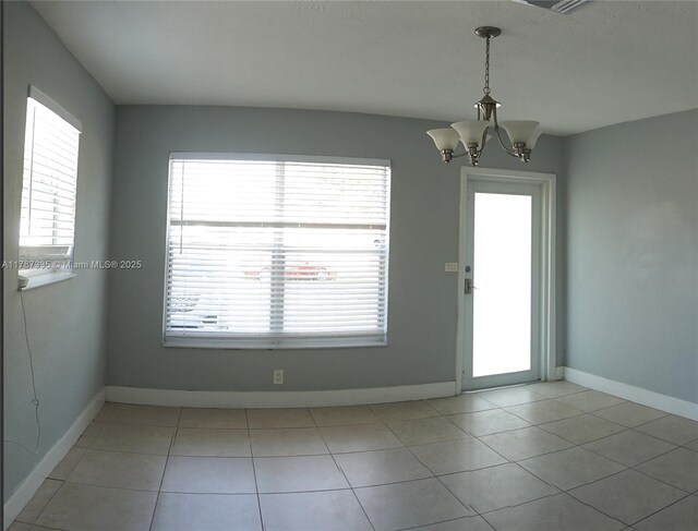 800 N 69th Ave, Hollywood, FL 33024 - unfurnished dining area featuring a chandelier, baseboards, and light tile patterned floors