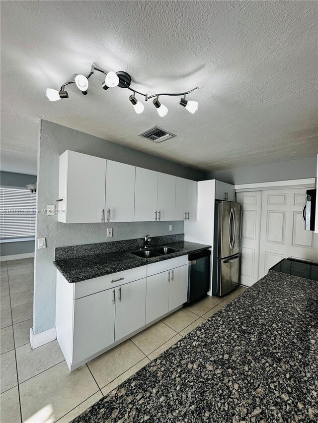 800 N 69th Ave, Hollywood, FL 33024 - kitchen featuring freestanding refrigerator, dishwasher, a sink, light tile patterned flooring, and white cabinetry