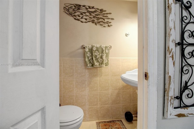 301 NW 109th Ave Unit 201, Miami, FL 33172 - bathroom featuring toilet, wainscoting, and tile walls