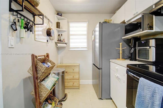 301 NW 109th Ave Unit 201, Miami, FL 33172 - kitchen with under cabinet range hood, open shelves, white cabinetry, light countertops, and appliances with stainless steel finishes