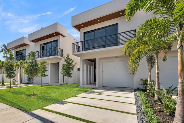 915 NE 17th Ter, Fort Lauderdale, FL 33304 - contemporary house with a garage, a front lawn, a balcony, and stucco siding