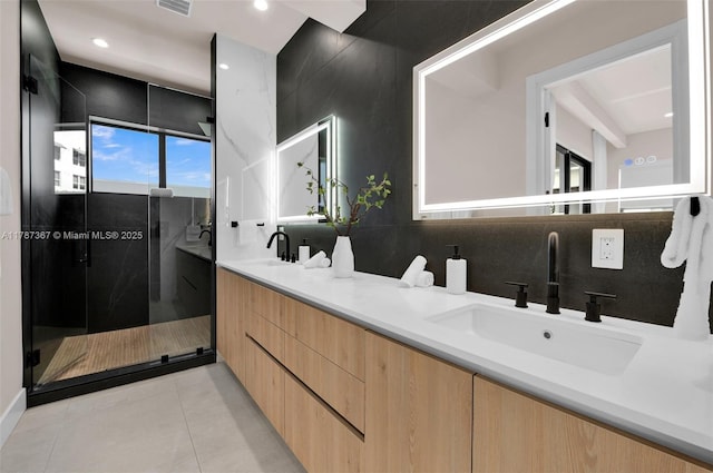 915 NE 17th Ter, Fort Lauderdale, FL 33304 - full bath featuring tile patterned floors, a sink, double vanity, visible vents, and a shower stall