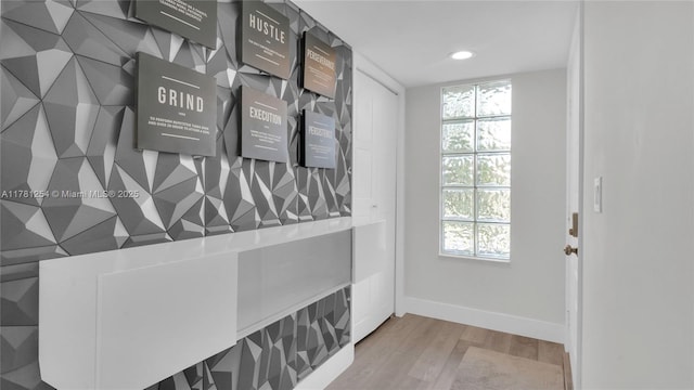 doorway featuring wood finished floors, baseboards, a wealth of natural light, and recessed lighting