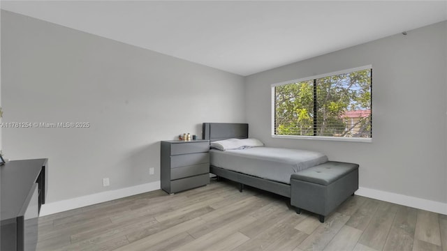 bedroom featuring baseboards and light wood-style floors