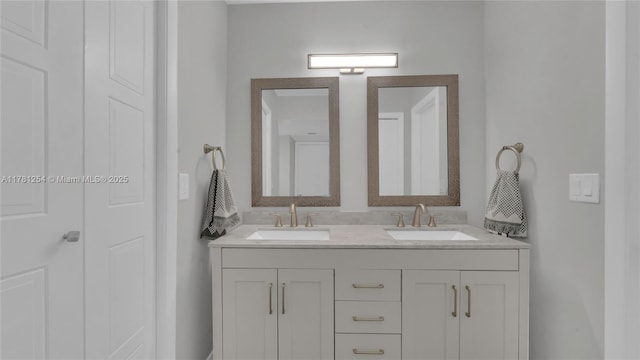 full bathroom with a sink and double vanity