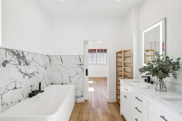 2905 Day Ave Unit 2A, Miami, FL 33133 - bathroom with a freestanding tub, wood finished floors, and double vanity