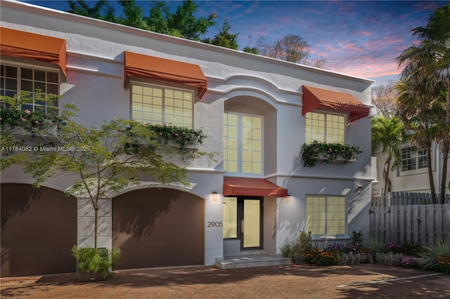 2905 Day Ave Unit 2A, Miami, FL 33133 - view of front of property featuring stucco siding, fence, and an attached garage
