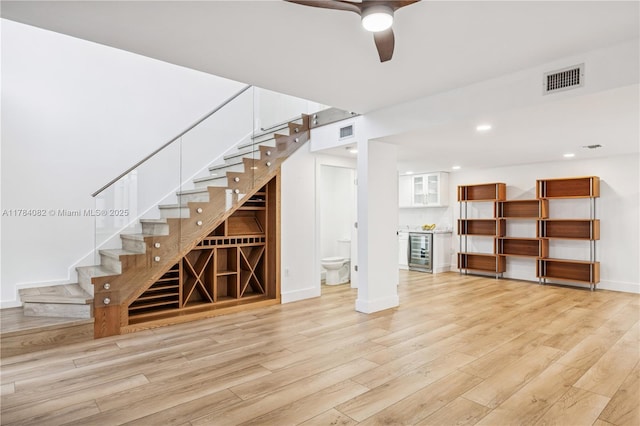 2905 Day Ave Unit 2A, Miami, FL 33133 - below grade area with beverage cooler, light wood-style flooring, a ceiling fan, stairs, and baseboards