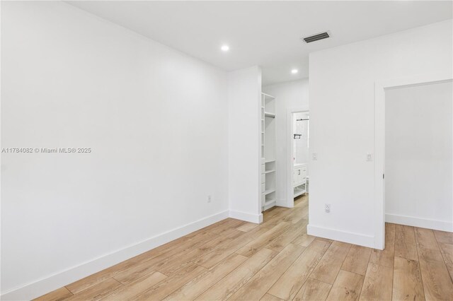 2905 Day Ave Unit 2A, Miami, FL 33133 - unfurnished bedroom with a spacious closet, light wood-style flooring, recessed lighting, baseboards, and a closet