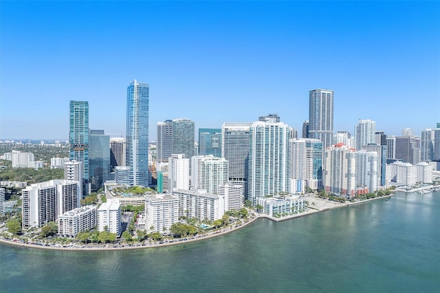 drone / aerial view of a view of skyline and a nearby body of water
