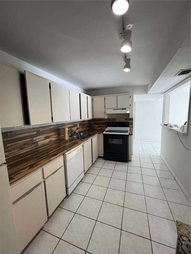 9124 Collins Ave Unit 304, Surfside, FL 33154 - kitchen featuring white dishwasher, decorative backsplash, range with electric stovetop, marble finish floor, and under cabinet range hood