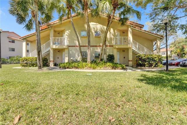3460 N Pinewalk Dr N Unit 321, Margate, FL 33063 - view of front facade featuring stairs, stucco siding, and a front lawn