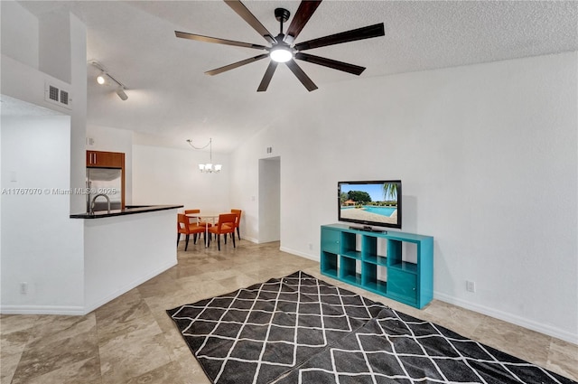 3460 N Pinewalk Dr N Unit 321, Margate, FL 33063 - living room with a chandelier, ceiling fan, lofted ceiling, rail lighting, and a textured ceiling