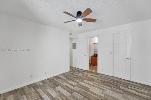 3460 N Pinewalk Dr N Unit 321, Margate, FL 33063 - unfurnished bedroom with wood finished floors, a textured ceiling, electric panel, ensuite bathroom, and ceiling fan
