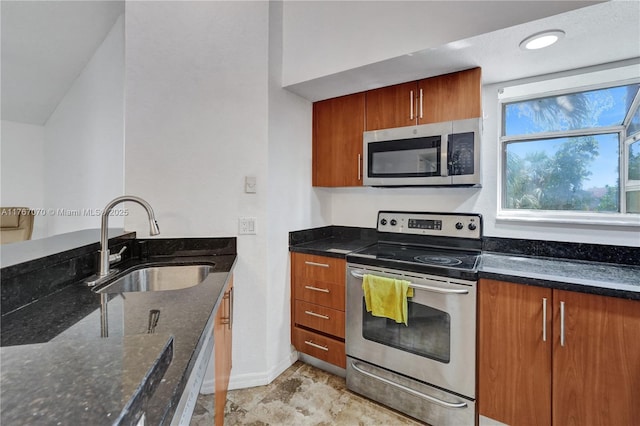 3460 N Pinewalk Dr N Unit 321, Margate, FL 33063 - kitchen featuring appliances with stainless steel finishes, dark stone counters, and brown cabinetry