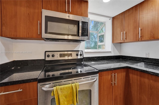 3460 N Pinewalk Dr N Unit 321, Margate, FL 33063 - kitchen with appliances with stainless steel finishes, brown cabinetry, and dark stone counters