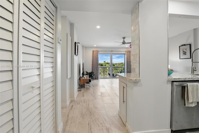 1831 NE 38th St Unit 402, Oakland Park, FL 33308 - corridor featuring light marble finish floors, recessed lighting, a sink, and baseboards