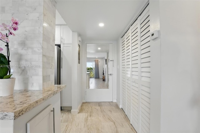 1831 NE 38th St Unit 402, Oakland Park, FL 33308 - hallway featuring recessed lighting, light marble finish floors, and baseboards