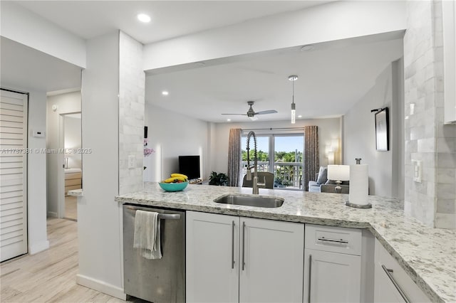 1831 NE 38th St Unit 402, Oakland Park, FL 33308 - kitchen featuring dishwasher, a ceiling fan, light stone counters, white cabinetry, and recessed lighting