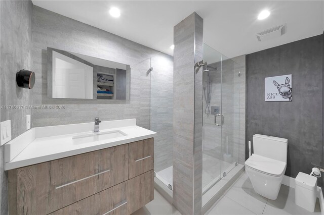 6694 NW 107th Pl, Doral, FL 33178 - full bathroom with toilet, a stall shower, vanity, tile walls, and tile patterned floors