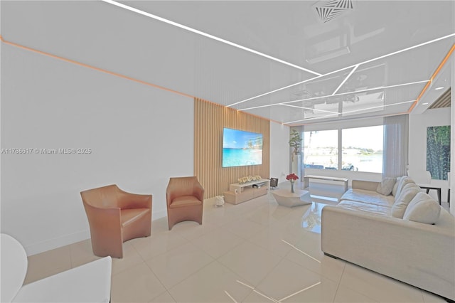 tiled living area with baseboards and visible vents
