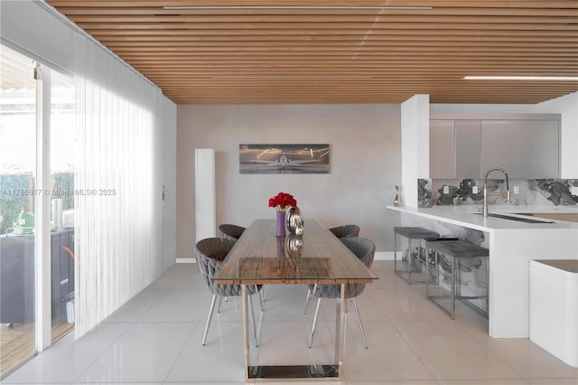dining room with wooden ceiling and light tile patterned floors