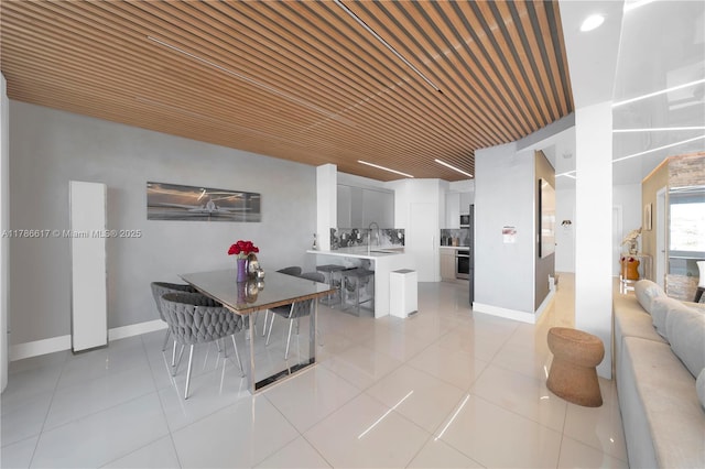 dining area featuring baseboards and light tile patterned flooring