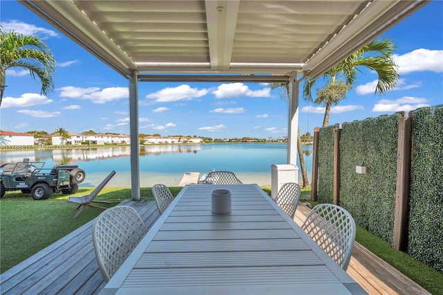 view of dock featuring a water view, a yard, and outdoor dining space