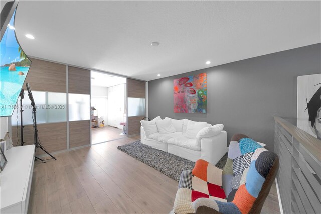 living room featuring light wood finished floors and recessed lighting