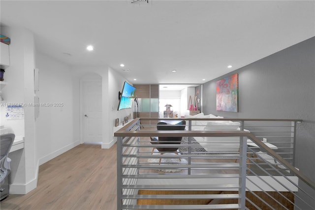 kitchen with recessed lighting, wood finished floors, and baseboards