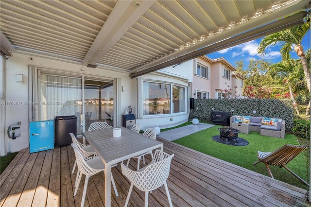 6694 NW 107th Pl, Doral, FL 33178 - wooden deck with an outdoor living space with a fire pit and a lawn