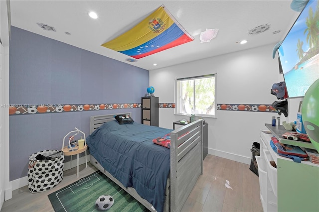 bedroom featuring wood finished floors and recessed lighting