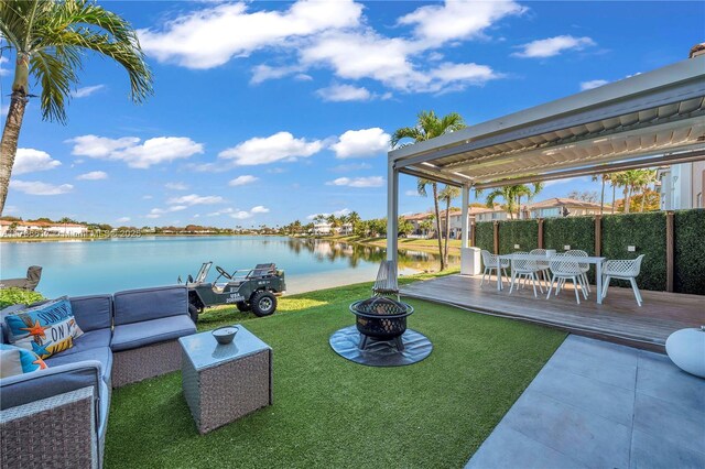 6694 NW 107th Pl, Doral, FL 33178 - view of green lawn featuring an outdoor living space with a fire pit, a deck with water view, and outdoor dining area
