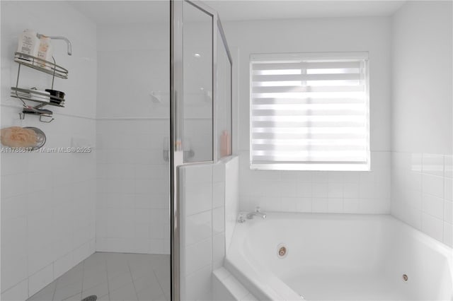 full bath featuring a stall shower and a jetted tub