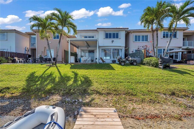 6694 NW 107th Pl, Doral, FL 33178 - back of property with stucco siding and a yard