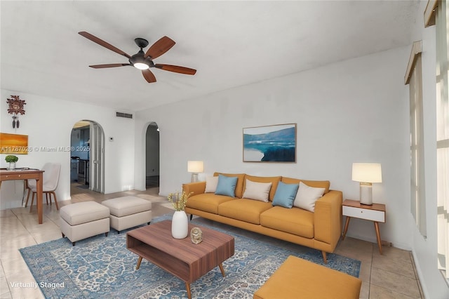 3111 Coral Springs Dr Unit 211, Coral Springs, FL 33065 - living area with arched walkways, ceiling fan, and tile patterned floors