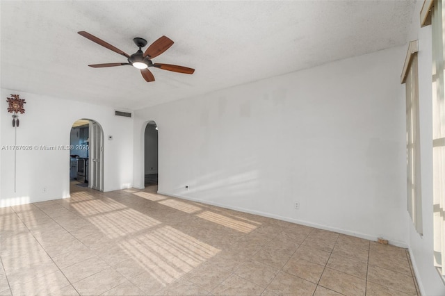 3111 Coral Springs Dr Unit 211, Coral Springs, FL 33065 - spare room featuring arched walkways, a ceiling fan, and a textured ceiling