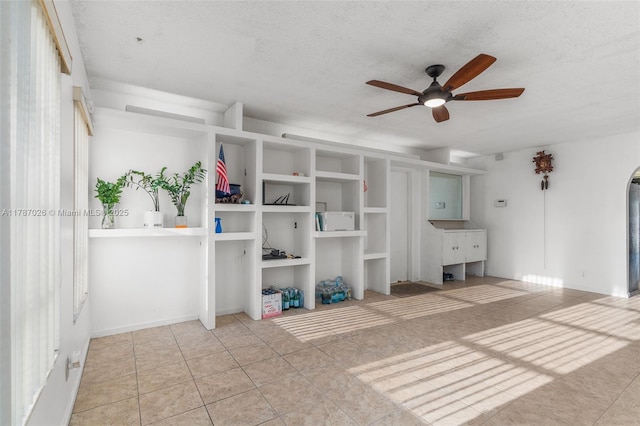 3111 Coral Springs Dr Unit 211, Coral Springs, FL 33065 - unfurnished living room with ceiling fan, tile patterned floors, and a textured ceiling