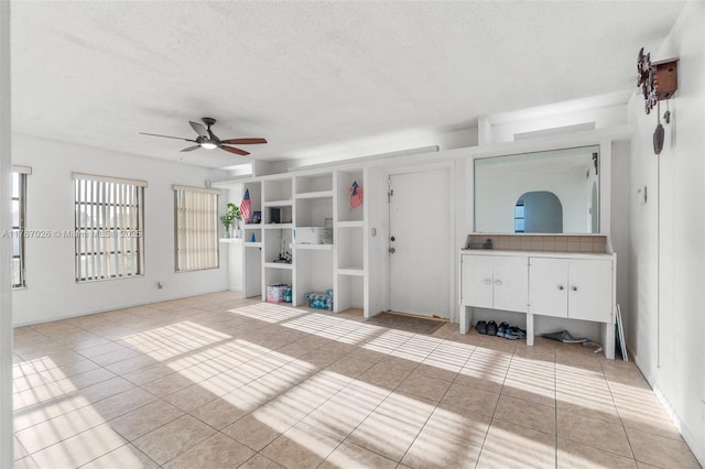 3111 Coral Springs Dr Unit 211, Coral Springs, FL 33065 - unfurnished living room with a ceiling fan, light tile patterned floors, and a textured ceiling