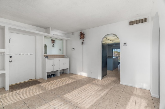 3111 Coral Springs Dr Unit 211, Coral Springs, FL 33065 - spare room with arched walkways and light tile patterned flooring