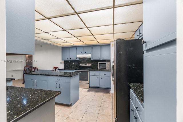 3111 Coral Springs Dr Unit 211, Coral Springs, FL 33065 - kitchen featuring stainless steel appliances, under cabinet range hood, a drop ceiling, light tile patterned floors, and tasteful backsplash