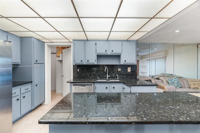 3111 Coral Springs Dr Unit 211, Coral Springs, FL 33065 - kitchen featuring a sink, appliances with stainless steel finishes, light tile patterned floors, backsplash, and a paneled ceiling