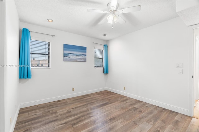 3111 Coral Springs Dr Unit 211, Coral Springs, FL 33065 - empty room with wood finished floors, a textured ceiling, and baseboards