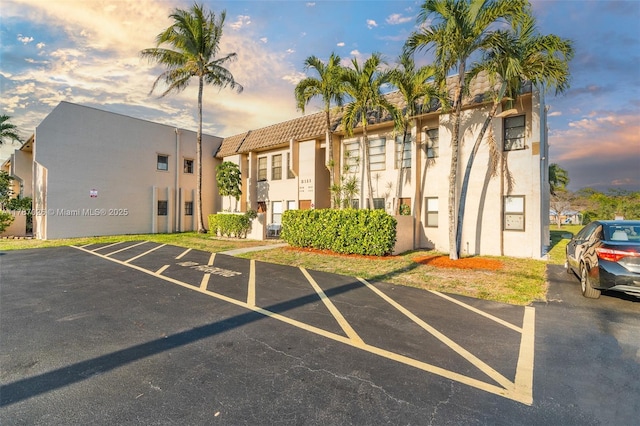 3111 Coral Springs Dr Unit 211, Coral Springs, FL 33065 - property at dusk with uncovered parking