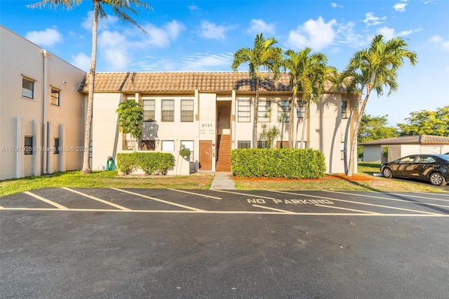 3111 Coral Springs Dr Unit 211, Coral Springs, FL 33065 - view of building exterior with uncovered parking